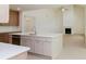 Open concept kitchen featuring a large island connecting to the living room with fireplace at 6585 Rhett Run, Cumming, GA 30028