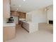 Spacious kitchen with large island, connecting to the living room with fireplace at 6585 Rhett Run, Cumming, GA 30028