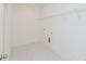 Bright laundry room with tile floors, shelving, and utility connections at 6585 Rhett Run, Cumming, GA 30028