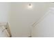Bright, white staircase with white walls, lit by modern lighting fixtures at 6585 Rhett Run, Cumming, GA 30028