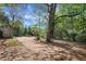 Spacious backyard featuring ample parking and a quaint storage shed, surrounded by mature trees at 108 Glenn St, Decatur, GA 30030