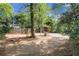 The backyard offers a secluded feel, with a storage shed, wooden fence and surrounding trees at 108 Glenn St, Decatur, GA 30030