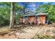 Backyard featuring brick home, patio, air conditioning units and landscaping at 108 Glenn St, Decatur, GA 30030