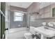 Well-lit bathroom with shower, tub, and tiled walls and floor at 108 Glenn St, Decatur, GA 30030