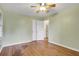 Light-filled bedroom features hardwood floors, a ceiling fan, and a spacious closet at 108 Glenn St, Decatur, GA 30030