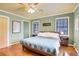 Cozy bedroom featuring hardwood floors, a ceiling fan, and natural light from two windows at 108 Glenn St, Decatur, GA 30030