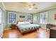 Bedroom with three windows, hardwood floors, ceiling fan, and neutral wall color at 108 Glenn St, Decatur, GA 30030