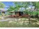 Charming brick home featuring a well-manicured front yard, mature landscaping, and a welcoming walkway at 108 Glenn St, Decatur, GA 30030