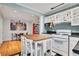 Bright kitchen with white cabinets, black countertops, butcher block island, and checkerboard floors at 108 Glenn St, Decatur, GA 30030
