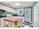 Bright kitchen with white cabinets, black countertops, butcher block island, and checkerboard floors at 108 Glenn St, Decatur, GA 30030