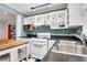 Bright kitchen with white cabinets, black countertops, stainless sink, and checkerboard floors at 108 Glenn St, Decatur, GA 30030