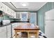Bright kitchen with white cabinets, black countertops, butcher block island, and checkerboard floors at 108 Glenn St, Decatur, GA 30030