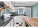 Bright kitchen with white cabinets, black countertops, butcher block island, and checkerboard floors at 108 Glenn St, Decatur, GA 30030