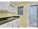 Functional kitchen space featuring a double sink, built-in shelves, and access to the exterior at 108 Glenn St, Decatur, GA 30030