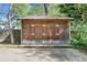This backyard features a spacious wooden storage shed with double doors, perfect for storing equipment and tools at 108 Glenn St, Decatur, GA 30030