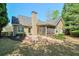 Backyard with screened-in porch, landscaped yard, stepping stones, and mature trees at 206 Mountain Vista Blvd, Canton, GA 30115