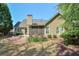 Spacious backyard featuring a screened-in porch, manicured lawn, and mature trees at 206 Mountain Vista Blvd, Canton, GA 30115