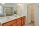 Bathroom featuring double sinks, wood cabinets, and a glass shower at 206 Mountain Vista Blvd, Canton, GA 30115