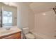Bright bathroom with tub and shower combination, white tiled walls, vanity with sink and window at 206 Mountain Vista Blvd, Canton, GA 30115