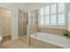 Bright bathroom featuring soaking tub and glass enclosed shower at 206 Mountain Vista Blvd, Canton, GA 30115