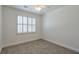Bedroom with a large window with shuttered blinds, neutral carpet, and white trim at 206 Mountain Vista Blvd, Canton, GA 30115