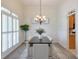 Formal dining room featuring wainscoting, plantation shutters, and a contemporary chandelier for elegant meals at 206 Mountain Vista Blvd, Canton, GA 30115