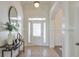 Welcoming foyer features tile flooring, an elegant mirror, and a stylish console table showcasing the home's modern aesthetic at 206 Mountain Vista Blvd, Canton, GA 30115