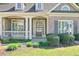 Inviting front porch with detailed columns and manicured landscaping at 206 Mountain Vista Blvd, Canton, GA 30115