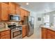 This kitchen features stainless steel appliances, granite countertops, and seamless access to a cozy dining area at 206 Mountain Vista Blvd, Canton, GA 30115