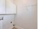 Laundry room with white cabinets, connections for washer and dryer, tile flooring, and wire shelving at 206 Mountain Vista Blvd, Canton, GA 30115