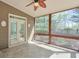 Screened-in porch with tile flooring, ceiling fan, and view of the backyard and surrounding trees at 206 Mountain Vista Blvd, Canton, GA 30115