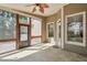 The sunroom has tile flooring, a ceiling fan, screens, and access to the backyard at 206 Mountain Vista Blvd, Canton, GA 30115