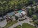Aerial view showcasing community amenities: pool, tennis courts, clubhouse, and lush greenery at 392 Mill Pond Cossing, Carrollton, GA 30116