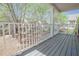View of the balcony with a white railing overlooking a landscaped lawn with trees at 392 Mill Pond Cossing, Carrollton, GA 30116