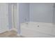 Bathroom showcasing a soaking tub with a separate shower and a neutral tile floor at 392 Mill Pond Cossing, Carrollton, GA 30116