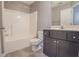 Bathroom features a vanity with dark wood cabinets, a toilet, and a shower tub combination at 392 Mill Pond Cossing, Carrollton, GA 30116