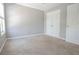 Neutral bedroom with plush carpeting and white closets, creating a serene and inviting space at 392 Mill Pond Cossing, Carrollton, GA 30116