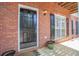 Inviting front entrance featuring a black door with decorative hardware and a manicured garden at 392 Mill Pond Cossing, Carrollton, GA 30116