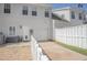 Back exterior featuring a white fence, garage door, and well-maintained yard, enhancing curb appeal at 392 Mill Pond Cossing, Carrollton, GA 30116