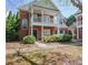 Charming two-story brick home featuring a covered porch and a well-maintained landscaped front yard at 392 Mill Pond Cossing, Carrollton, GA 30116