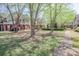 A serene community lawn with mature trees and well-maintained landscaping at 392 Mill Pond Cossing, Carrollton, GA 30116