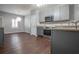 Modern kitchen with gray cabinets, stainless steel appliances, and wood flooring at 392 Mill Pond Cossing, Carrollton, GA 30116