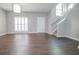 Bright living room featuring wood floors, neutral walls, and staircase access at 392 Mill Pond Cossing, Carrollton, GA 30116