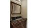 Elegant powder room with a dark wood vanity and decorative mirror at 636 Parkside Village Nw Way, Marietta, GA 30060