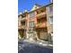 Multi-story townhome exterior featuring private patios, brick and stone facade, and two-car garages at 636 Parkside Village Nw Way, Marietta, GA 30060