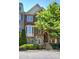 Charming brick and stone townhome with manicured landscaping and inviting entryway stairs at 636 Parkside Village Nw Way, Marietta, GA 30060