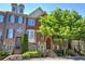 Attractive brick and stone townhomes with well-maintained landscaping and inviting entrances at 636 Parkside Village Nw Way, Marietta, GA 30060