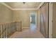 Hallway with a decorative sliding barn door and a wooden staircase railing at 636 Parkside Village Nw Way, Marietta, GA 30060