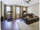 Inviting room with hardwood floors, a ceiling fan, exercise equipment and a comfortable couch at 636 Parkside Village Nw Way, Marietta, GA 30060