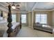 Spacious main bedroom with a four-poster bed, tray ceiling, and sitting area with ample natural light at 636 Parkside Village Nw Way, Marietta, GA 30060